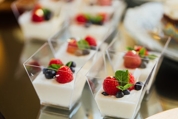 Snack at the wedding banquet in small shots of yogurt and berries.