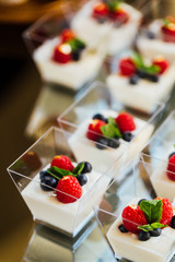 Snack at the wedding banquet in small shots of yogurt and berries.