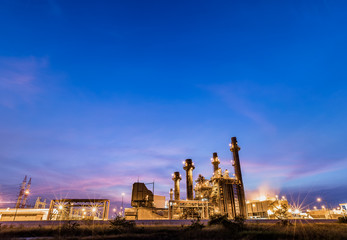 Gas combine electrical power plant at dusk with blue sky is support all factory in industrial estate
