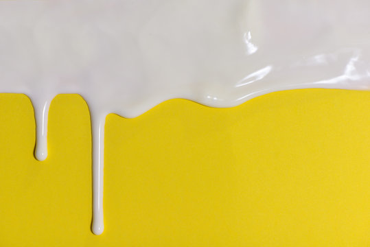 Thick White Paint Dripping Down The Yellow Wall.