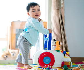 Asian baby training walking with walker toy © anekoho