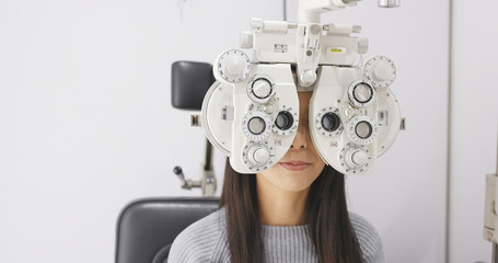 Asian Woman doing eye test in clinic