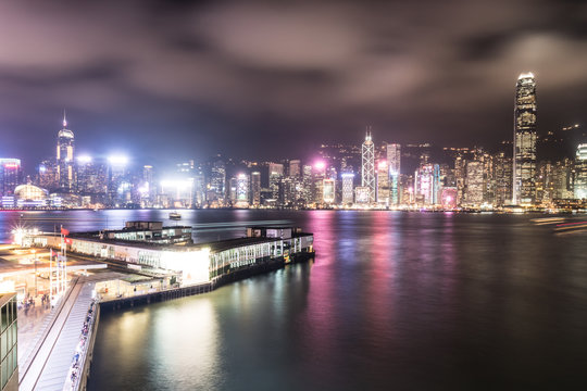 Stunning view of Hong Kong island skyline and the Star ferry pier in Kowloon at night