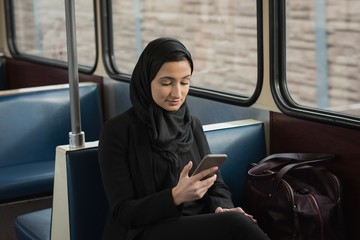 Woman in hijab using mobile phone