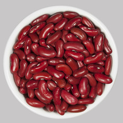 Red beans in a white cup on gray background