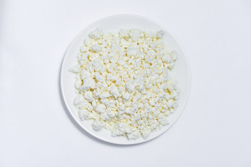 A bowl of homemade cottage cheese on a white background.