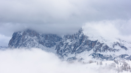 Fototapeta na wymiar Dolomites. Winter views in the fog and low clouds