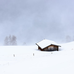 Hut in the snow. Magic atmosphere in the Dolomites