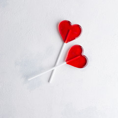 Two red Candy hearts on white concrete background. Minimal love concept. Romantic Style.  Creative...
