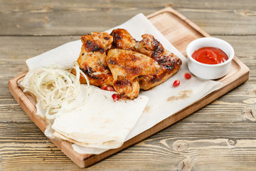 chicken wings grill. Serving on a wooden Board on a rustic table. Barbecue restaurant menu, a series of photos of different meats