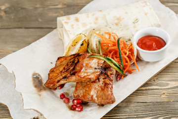 Grilled pork ribs. Serving on a wooden Board on a rustic table. Barbecue restaurant menu, a series of photos of different meats