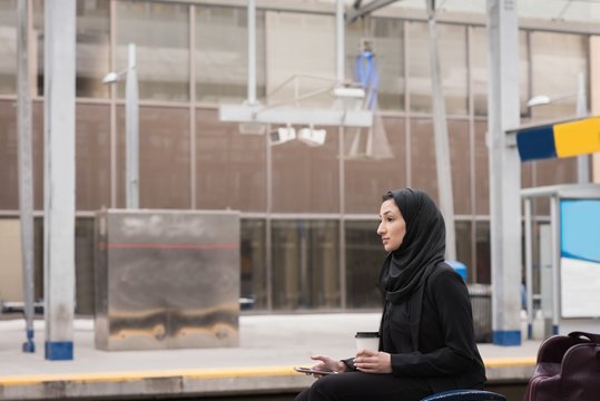Woman in hijab using mobile phone