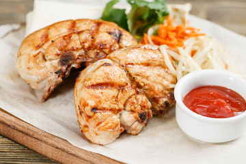 grilled chicken breast. Serving on a wooden Board on a rustic table. Barbecue restaurant menu, a series of photos of different meats