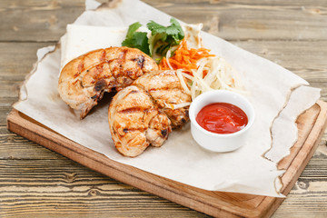 grilled chicken breast. Serving on a wooden Board on a rustic table. Barbecue restaurant menu, a series of photos of different meats