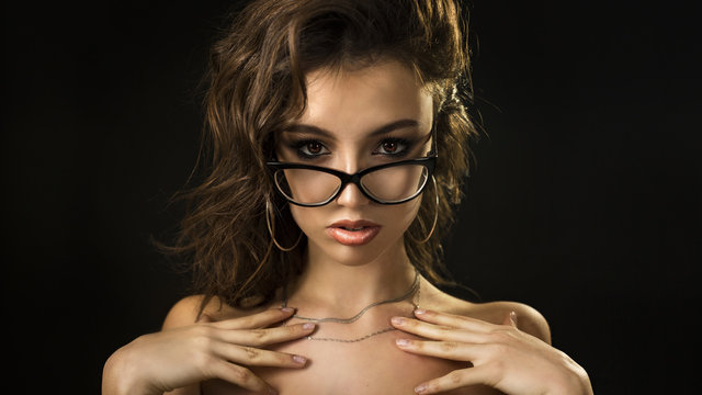 sexy girl posing on camera. dark background - Powered by Adobe