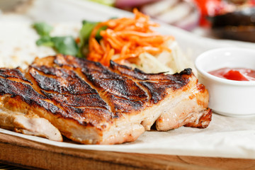 pork steak grill. Serving on a wooden Board on a rustic table. Barbecue restaurant menu, a series of photos of different meats