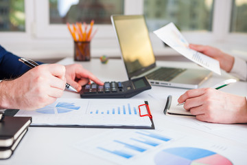 Team work process. Marketing strategy brainstorming. Paperwork and digital in office.