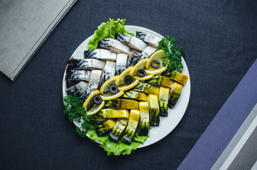 Herring and mackerel sliced on a plate beautifully laid out
