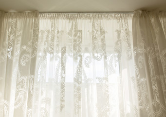Transparent tulle curtain in room with window