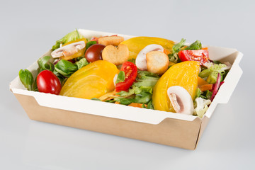 big salad in a cardboard dish of a fast food take away