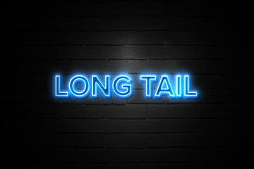 Long Tail neon Sign on brickwall