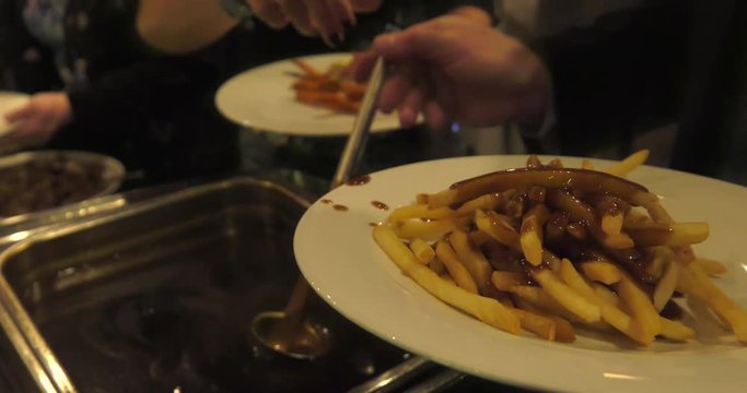 ladle full of gravy added to french fries 4k