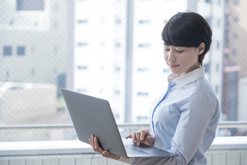 ノートパソコンを持つ女性