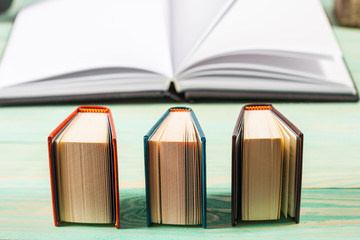 Pile of miniature books on wooden background. With copy space for your text