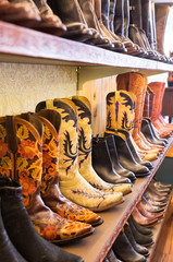 Cowboys boots on a shelf in a store, aligned