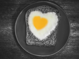 bread with fried eggs in the shape of a heart symbol