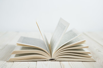 Obraz premium Open of pastel colorsbooks hardback on wooden table.