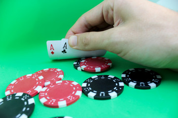 Man's hand holds a poker cards. Poker concept on black background. Close up. 