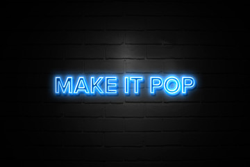 Make It Pop neon Sign on brickwall