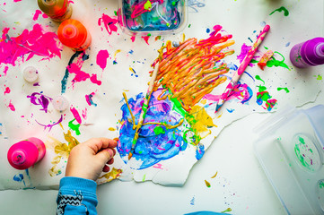Messy paint and child hand