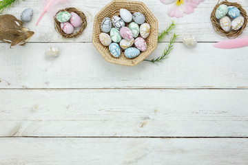 Top view shot of arrangement decoration Happy Easter holiday background concept.Flat lay colorful Easter egg with flower and rabbit doll on modern rustic white wooden at office desk.space for mock up