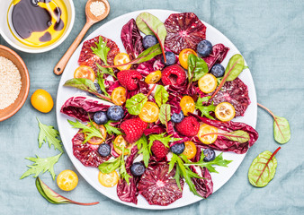 Vitamin salad super food bowl.Salad with blood orange and berries top view.