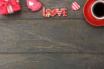 Table top view image of decoration valentine's day background concept.Flat lay heart shape and essential symbol love season with gift box on modern rustic brown wooden at home office desk studio.