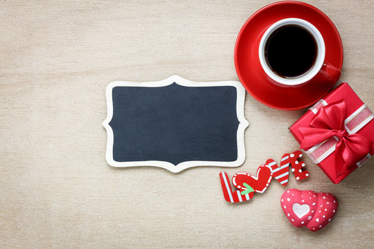 Table top view aerial image of decoration valentine's day background concept.Flat lay arrangement of blank space blackboard & essential items on modern rustic brown wood for mock up creative design