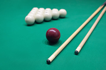 Billiard table with balls, cue and chalk for him