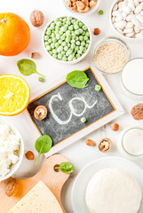 Healthy food concept. Set of food rich in calcium - dairy and vegan Ca products, white marble background top view