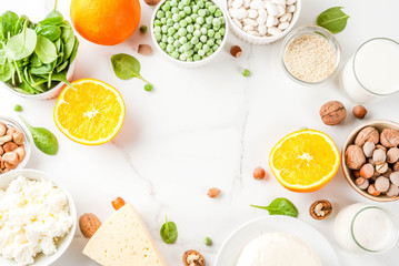 Healthy food concept. Set of food rich in calcium - dairy and vegan Ca products, white marble background top view copy space frame