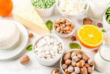 Healthy food concept. Set of food rich in calcium - dairy and vegan Ca products, white marble background top view