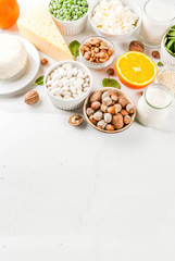 Healthy food concept. Set of food rich in calcium - dairy and vegan Ca products, white marble background copy space