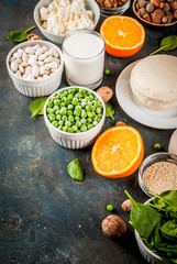 Healthy food concept. Set of food rich in calcium - dairy and vegan Ca products, dark blue background copy space