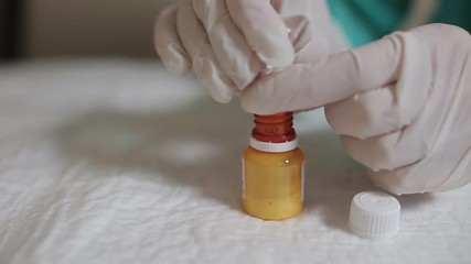 The nurse in the veterinary clinic gaining medicine into the syringe - Powered by Adobe