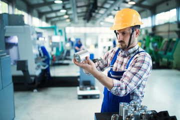 Portrait of an handsome engineer in a factory