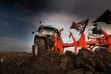 Tractor plowing fields -preparing land for sowing in autumn