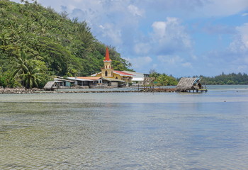 Huahine island church and fishing trap of Maeva village on the shore of the saltwater lake Fauna Nui, French Polynesia, south Pacific
