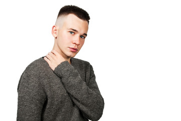 Portrait of white yong guy in gray sweater and short haircut, isolated on white.