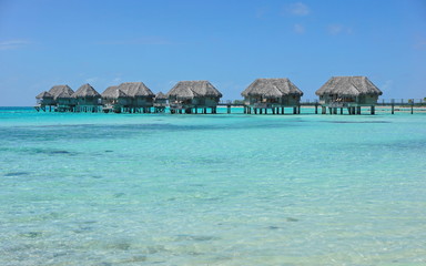 Tropical bungalows overwater in a lagoon with turquoise water, Tikehau atoll, Tuamotus, French Polynesia, Pacific ocean, Oceania